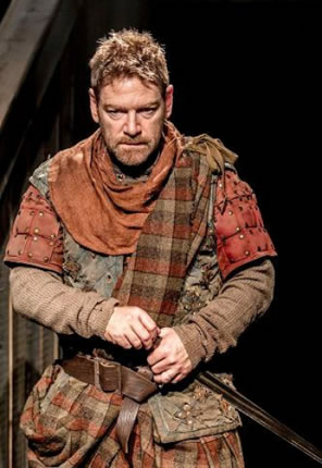 Branagh in orange and brown plad and ancient armor, dagger in hilt.