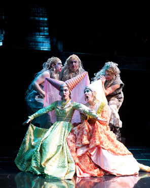 The three Weird Sisters in rags above and behind the two Stepsisters in bright gowns and pointy hats.